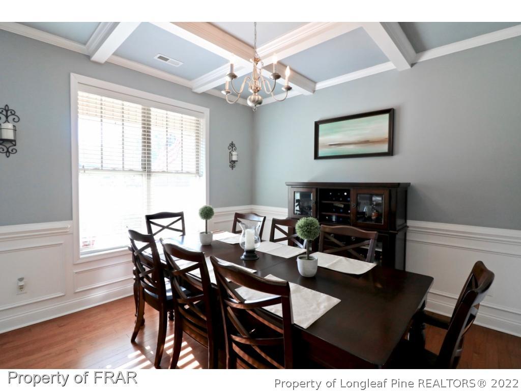 740 Sun Road Aberdeen, NC 28315 - Photo 5 of 36 a view of a dining room with furniture and chandelier