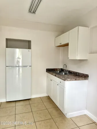 a kitchen with stainless steel appliances granite countertop a sink and a stove