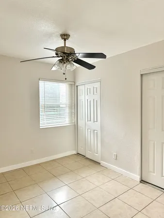 a view of a livingroom with a ceiling fan and window