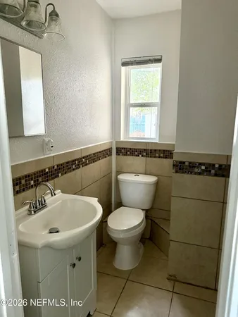 a bathroom with a toilet a sink and a window
