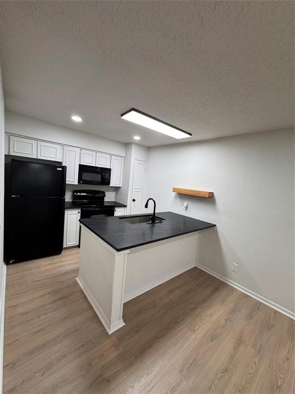 4859 Cedar Springs Road, Unit 150 Dallas, TX 75219 - Photo 12 of 24 a kitchen with granite countertop a sink and a refrigerator
