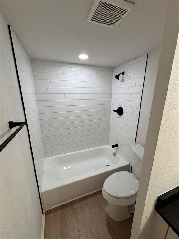 4859 Cedar Springs Road, Unit 150 Dallas, TX 75219 - Photo 13 of 24 a bathroom with a bathtub shower sink vanity mirror and toilet