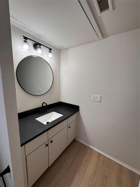 4859 Cedar Springs Road, Unit 150 Dallas, TX 75219 - Photo 14 of 24 a bathroom with a granite countertop sink and a mirror