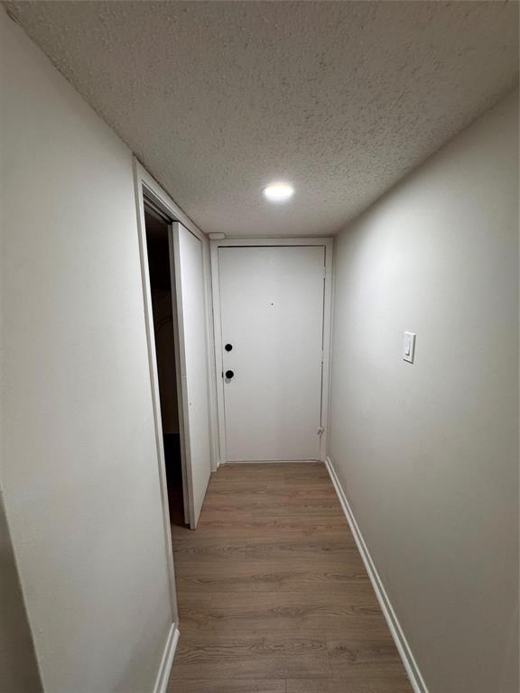 4859 Cedar Springs Road, Unit 150 Dallas, TX 75219 - Photo 20 of 24 an empty room with wooden floor and entrance