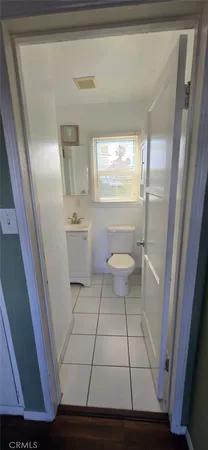 a bathroom with a toilet a sink a mirror and a shower