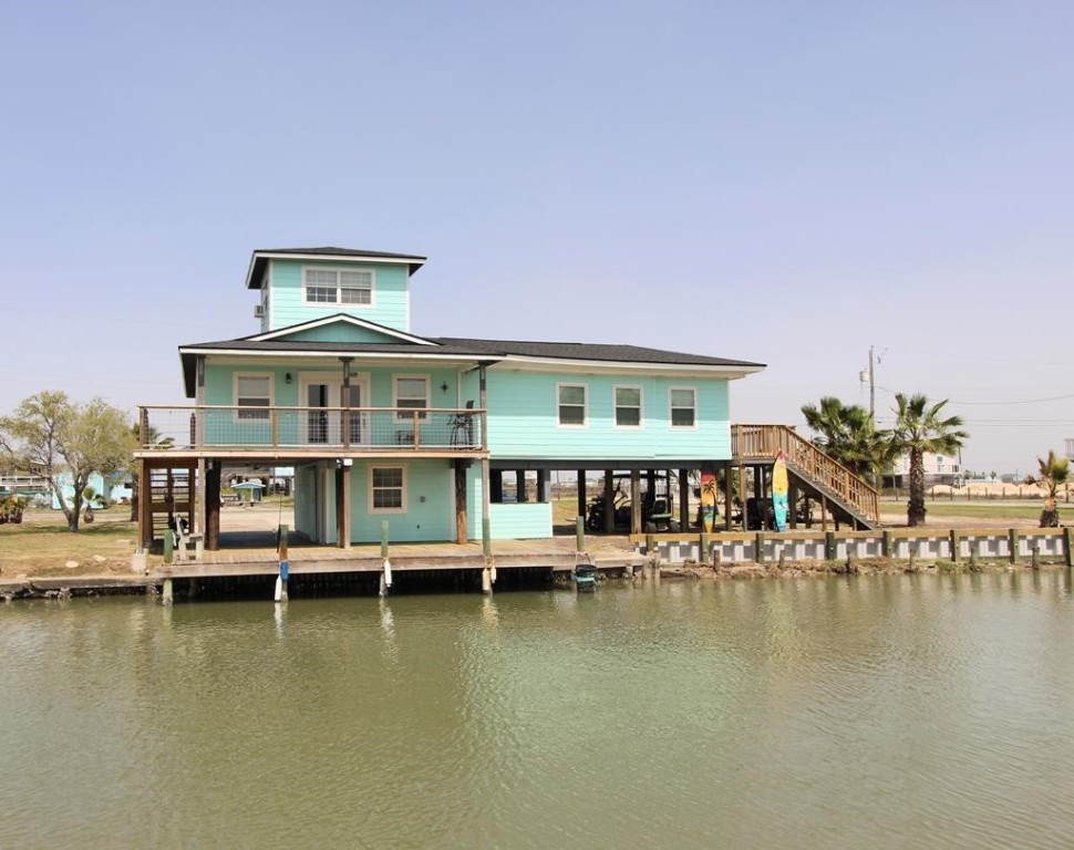 189 Sailfish Drive Rockport, TX 78382 - Photo 1 of 40 a view of an ocean with boats and trees in the background