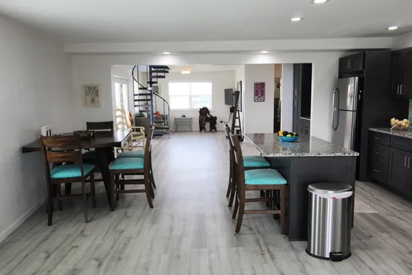 a view of a dining room with furniture window and wooden floor