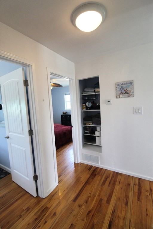 189 Sailfish Drive Rockport, TX 78382 - Photo 26 of 40 a view of a bedroom with wooden floor and closet