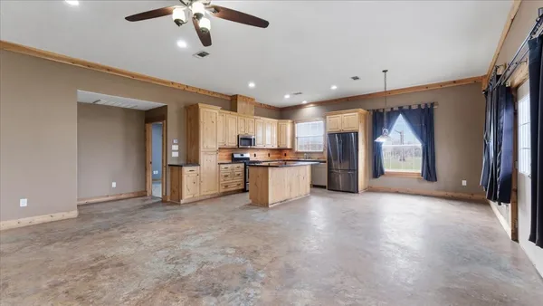 a view of a kitchen with a sink and a refrigerator