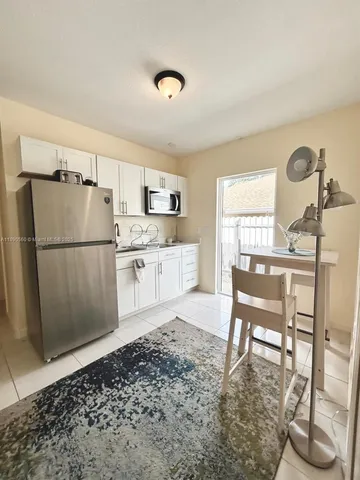 a kitchen with a table and chairs