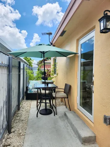 a patio with table and chairs