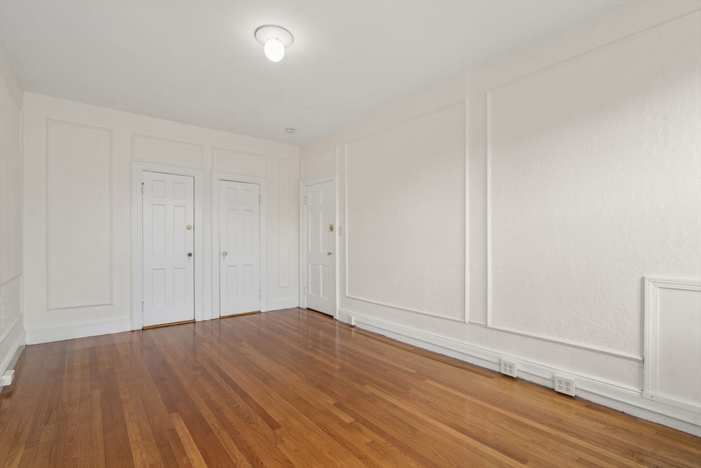 114 St Paul Street, Unit 5 Brookline, MA 02446 - Photo 15 of 22 a view of empty room with wooden floor