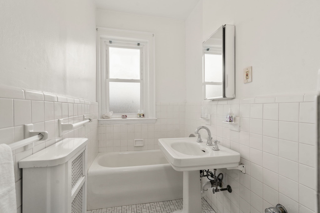 114 St Paul Street, Unit 5 Brookline, MA 02446 - Photo 16 of 22 a bathroom with a sink a tub and a mirror