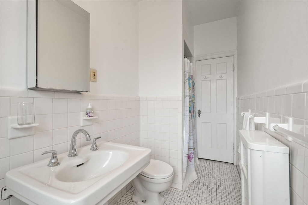 114 St Paul Street, Unit 5 Brookline, MA 02446 - Photo 17 of 22 a bathroom with a sink toilet and vanity