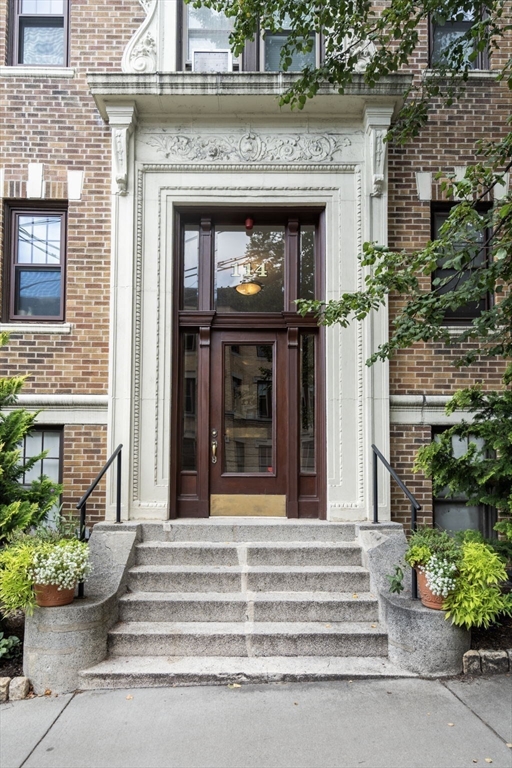 114 St Paul Street, Unit 5 Brookline, MA 02446 - Photo 20 of 22 a front view of a house with potted plants