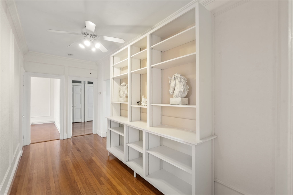 114 St Paul Street, Unit 5 Brookline, MA 02446 - Photo 3 of 22 a view of an empty room with wooden floor and a window