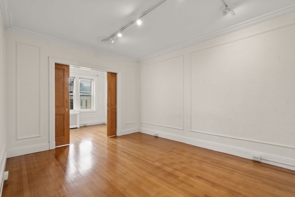 114 St Paul Street, Unit 5 Brookline, MA 02446 - Photo 6 of 22 wooden floor in an empty room