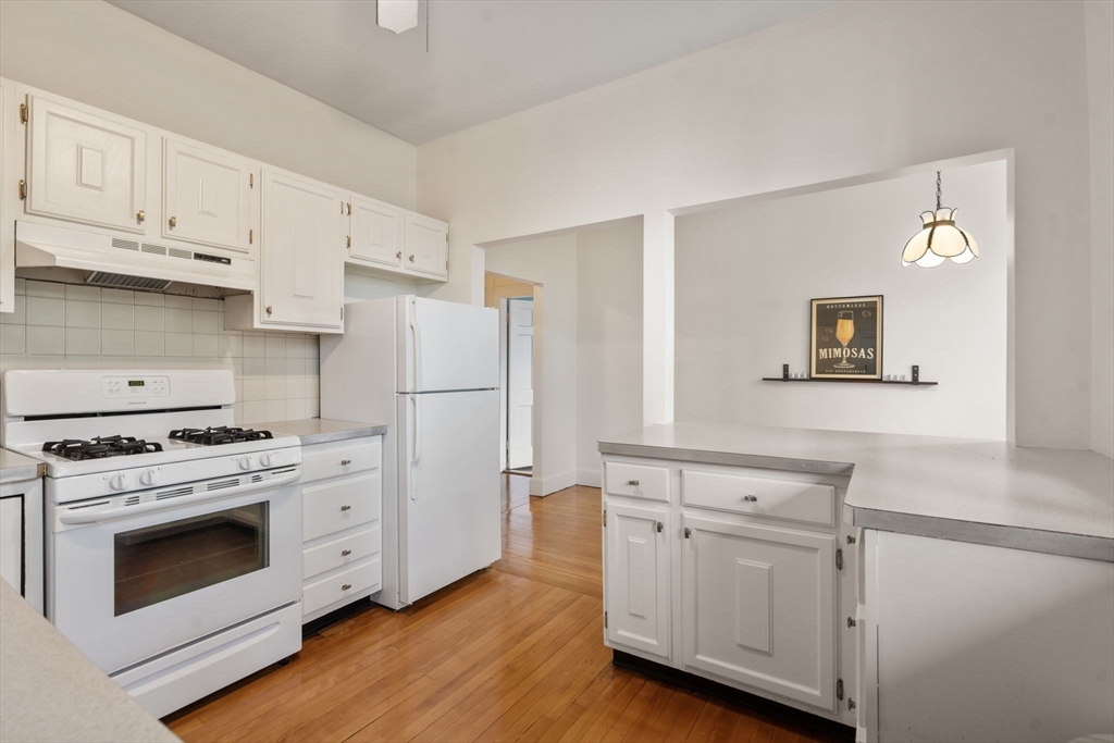 114 St Paul Street, Unit 5 Brookline, MA 02446 - Photo 10 of 22 a kitchen with cabinets appliances and wooden floor