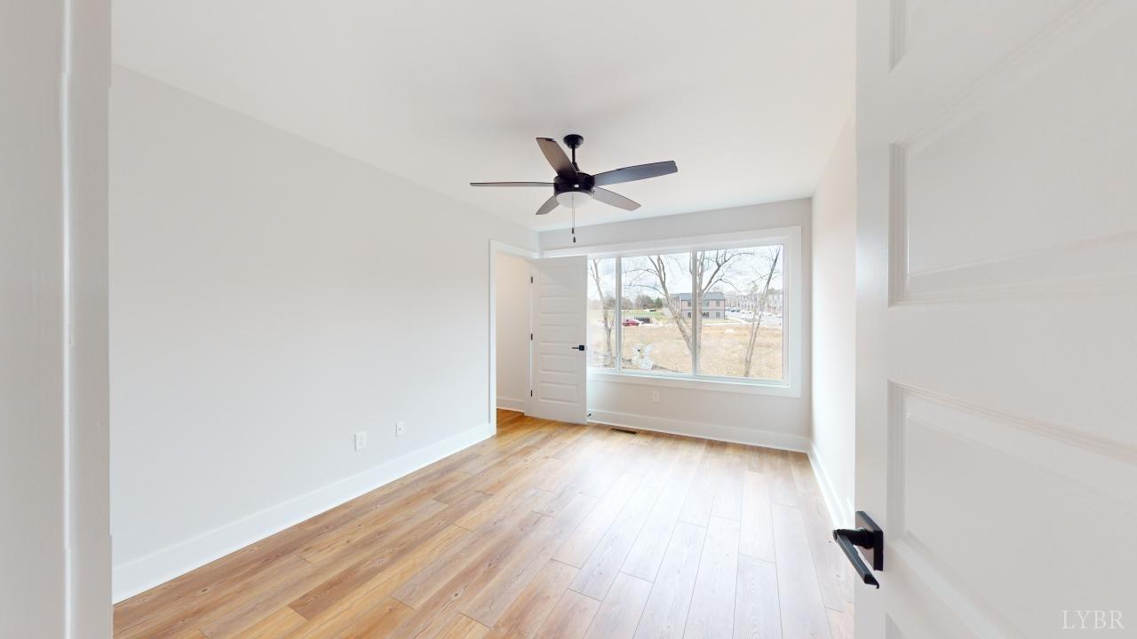 53 Shallen Road Rustburg, VA 24588 - Photo 26 of 46 an empty room with wooden floor and windows