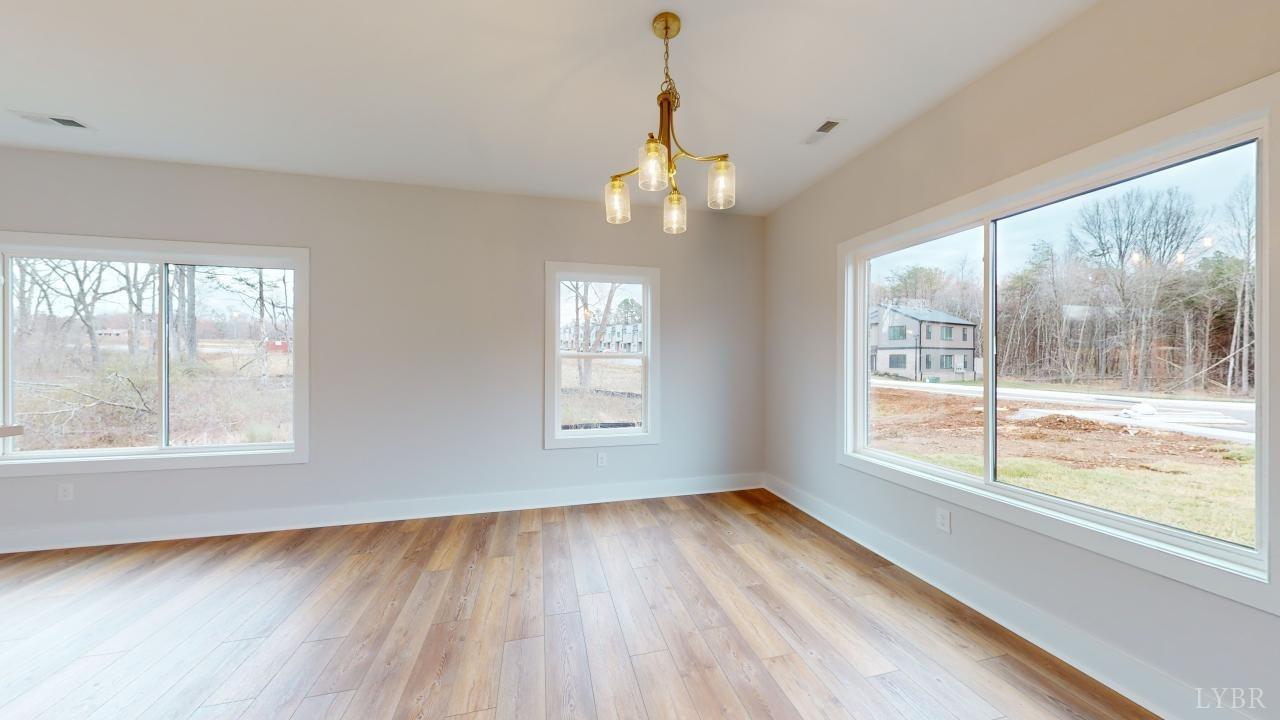 53 Shallen Road Rustburg, VA 24588 - Photo 6 of 46 a view of an empty room with wooden floor and a window