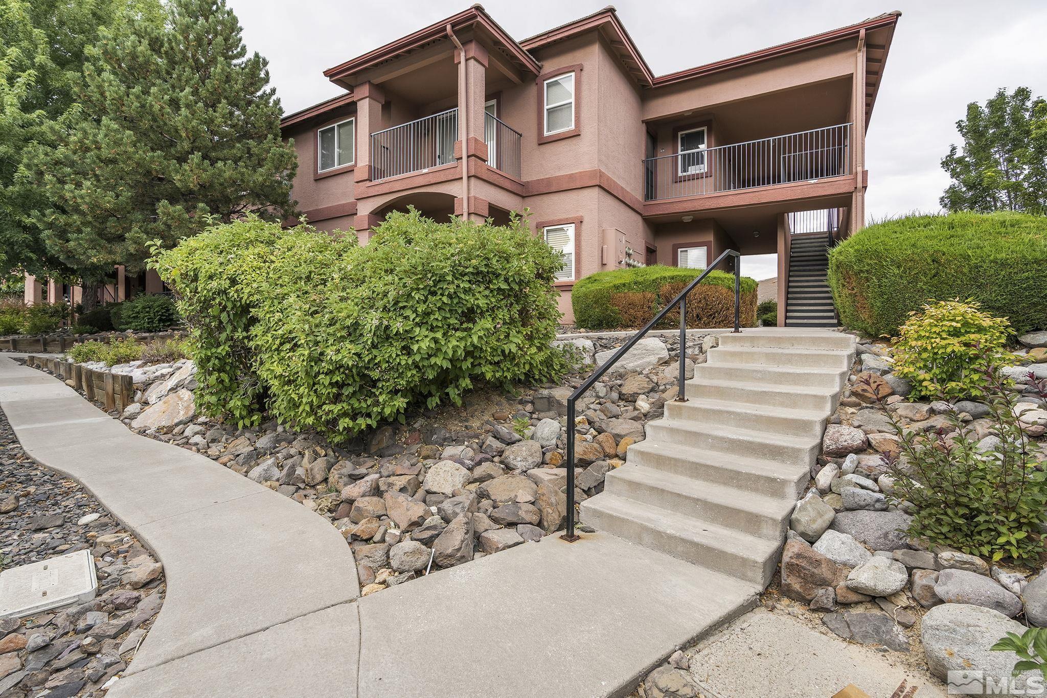 6850 Sharlands Avenue, Unit 2109 Reno, NV 89523 - Photo 1 of 16 a front view of a house with a yard and a garden