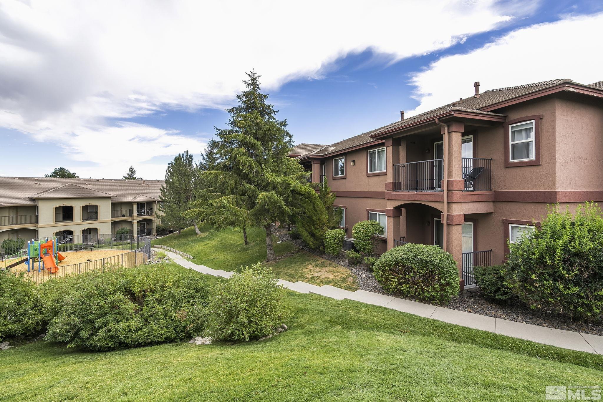 6850 Sharlands Avenue, Unit 2109 Reno, NV 89523 - Photo 2 of 16 a front view of a house with a yard