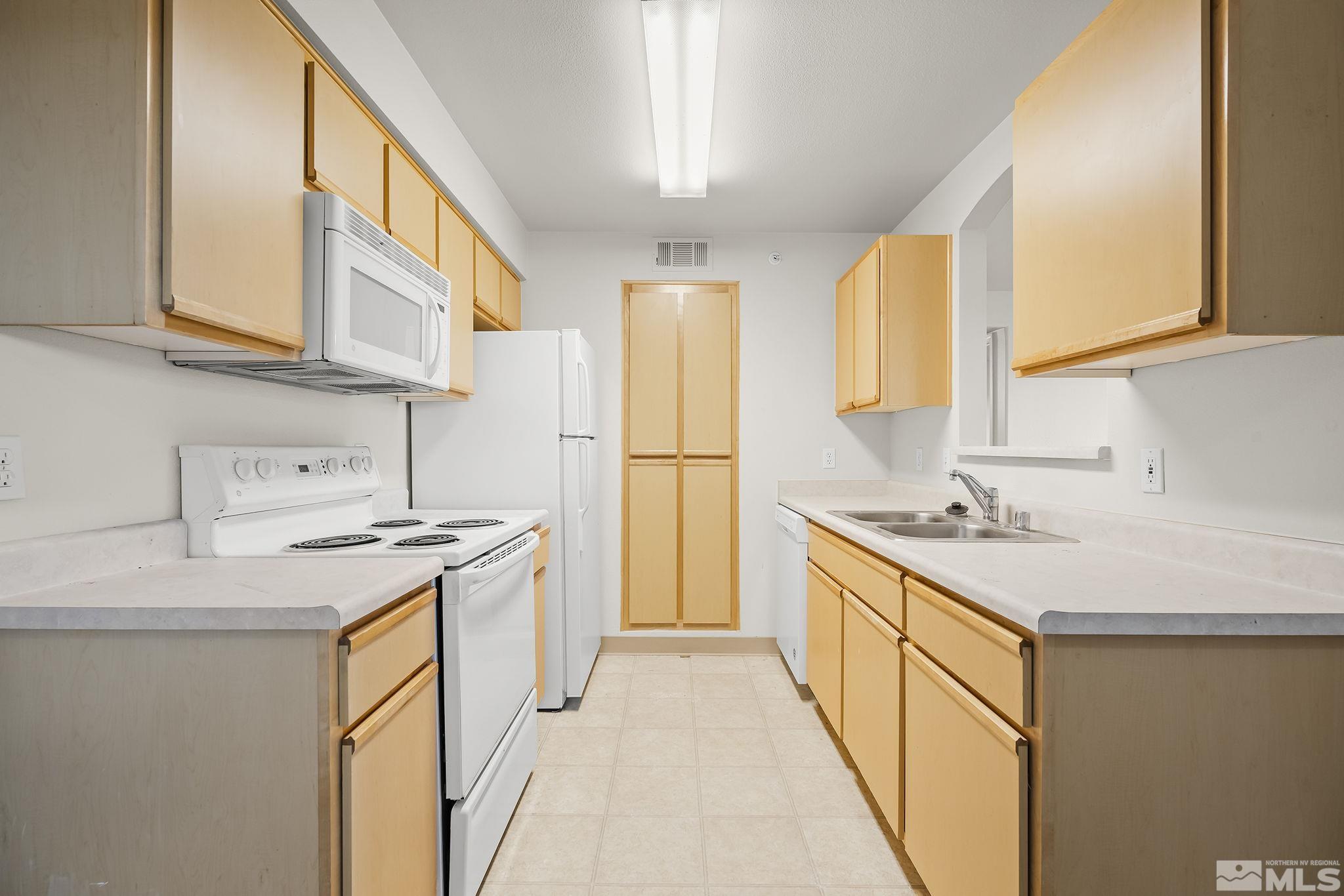 6850 Sharlands Avenue, Unit 2109 Reno, NV 89523 - Photo 9 of 16 a kitchen with stainless steel appliances granite countertop a sink stove and refrigerator