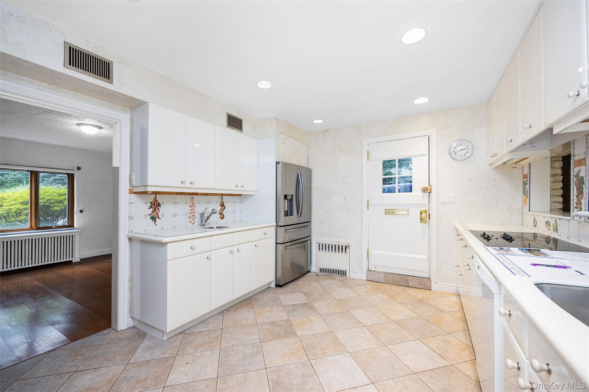 3 Buckingham Place Great Neck, NY 11021 - Photo 11 of 28 a kitchen with a sink stove and refrigerator