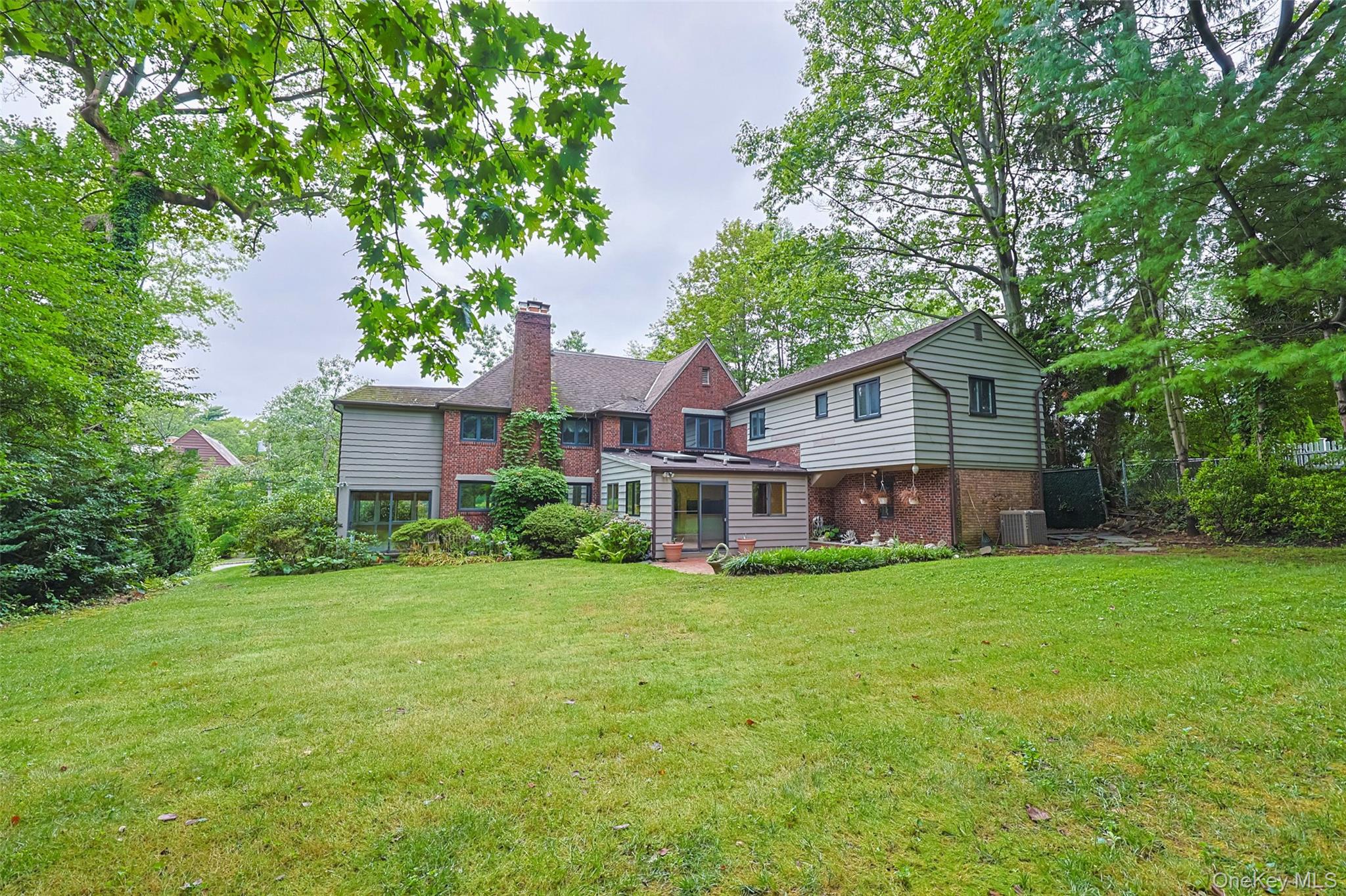3 Buckingham Place Great Neck, NY 11021 - Photo 26 of 28 a view of a house with a yard and sitting area