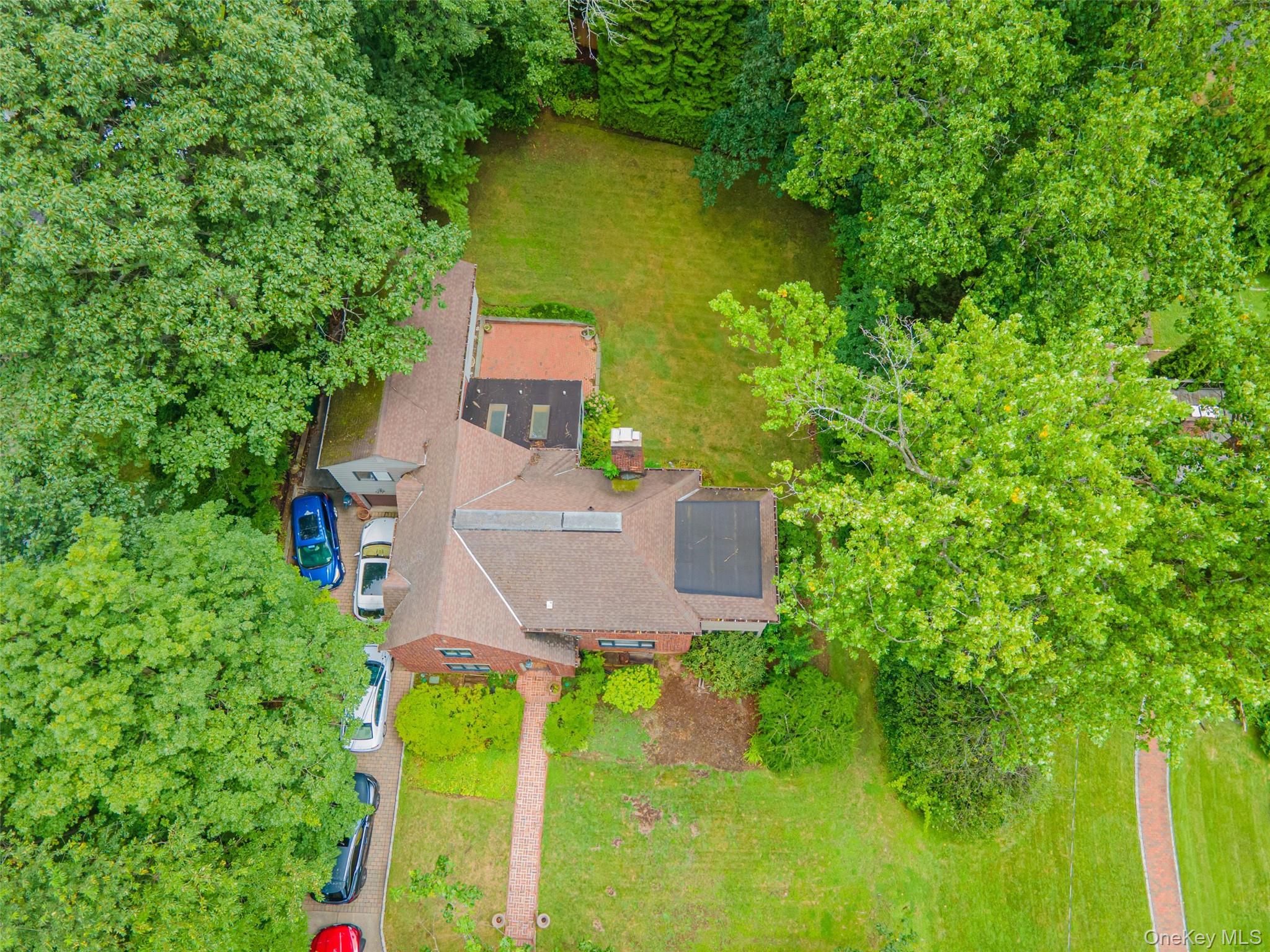 3 Buckingham Place Great Neck, NY 11021 - Photo 3 of 28 an aerial view of a house with swimming pool and garden