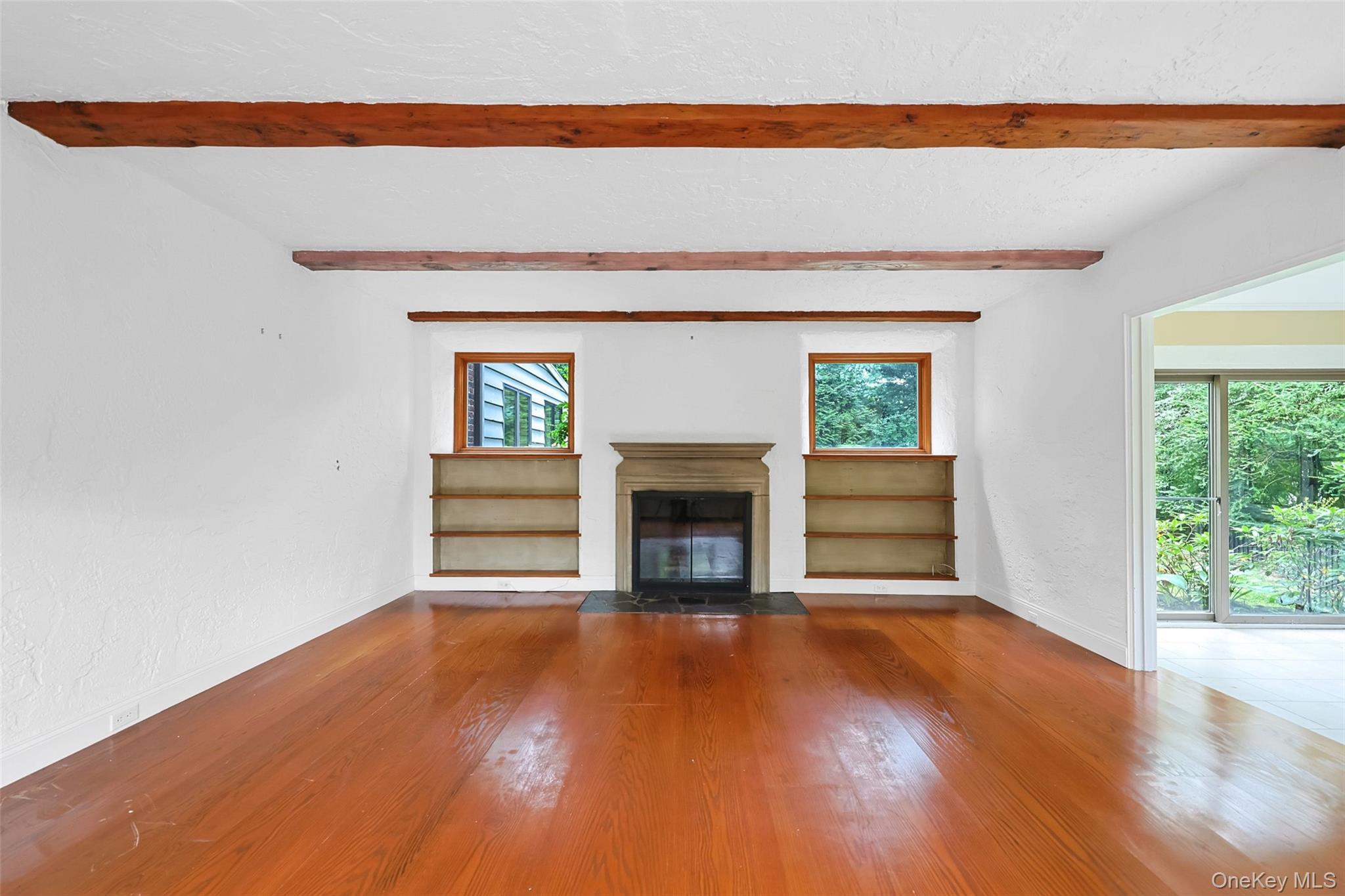 3 Buckingham Place Great Neck, NY 11021 - Photo 6 of 28 a view of empty room with wooden floor and fireplace