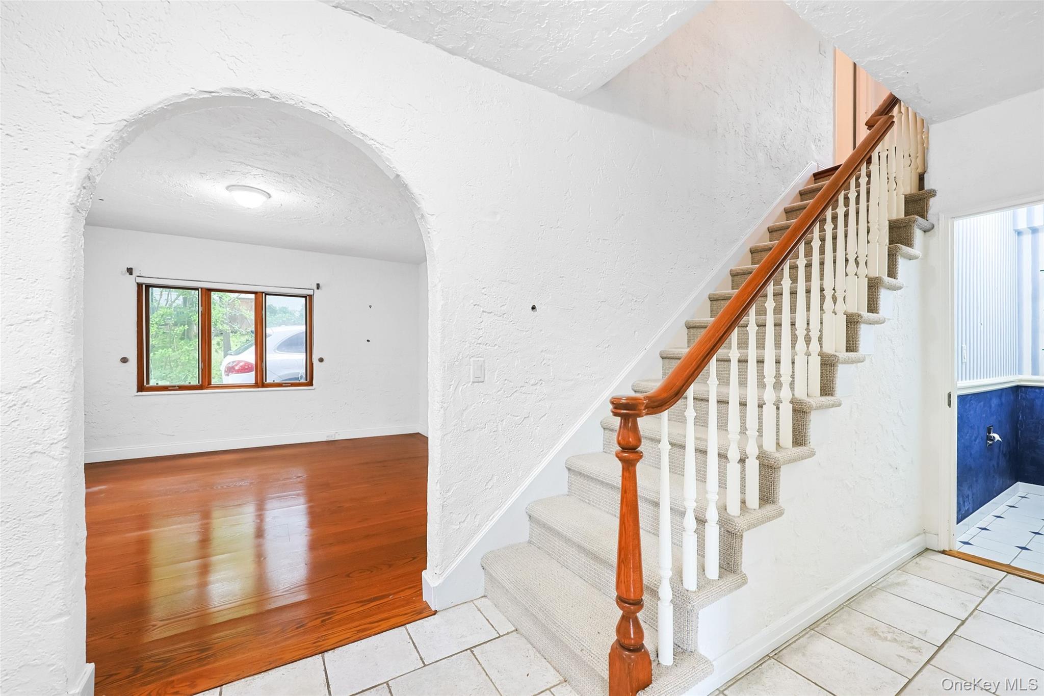 3 Buckingham Place Great Neck, NY 11021 - Photo 9 of 28 a view of staircase with railing and a chandelier