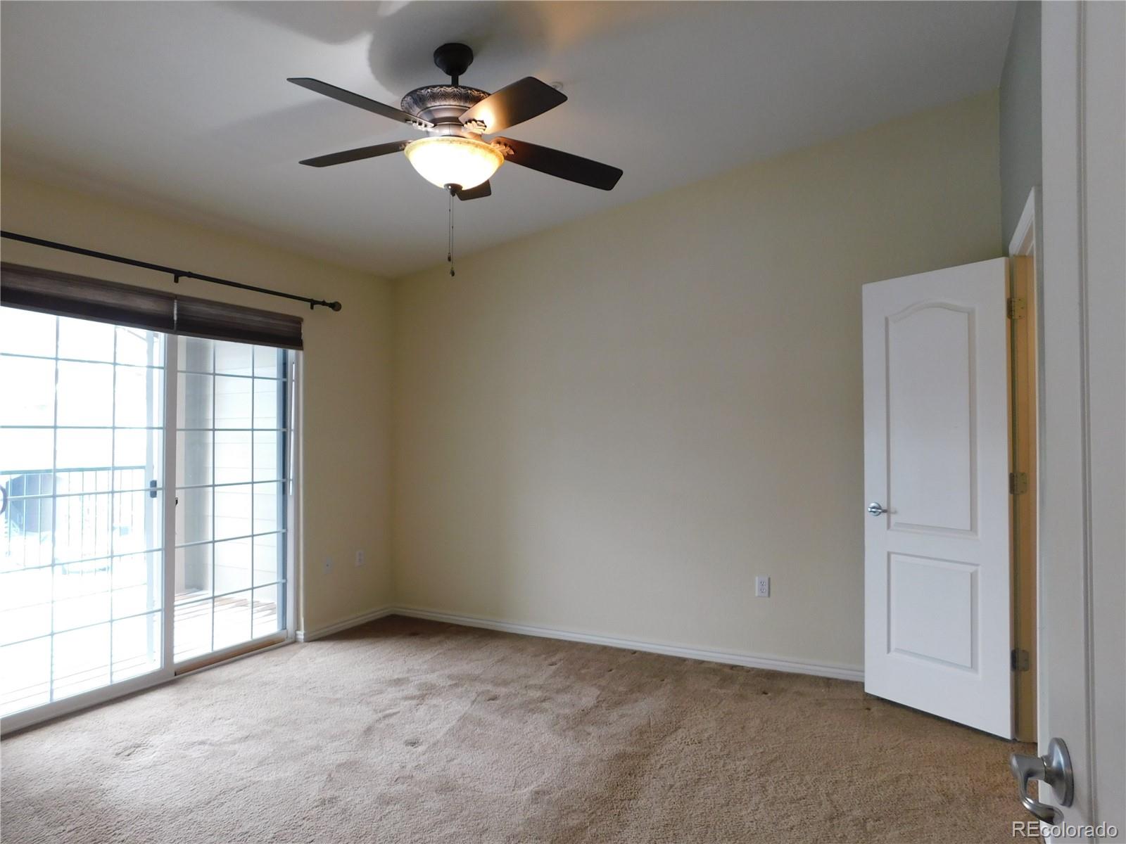 18669 Stroh Road, Unit 10204 Parker, CO 80134 - Photo 15 of 28 an empty room with chandelier fan