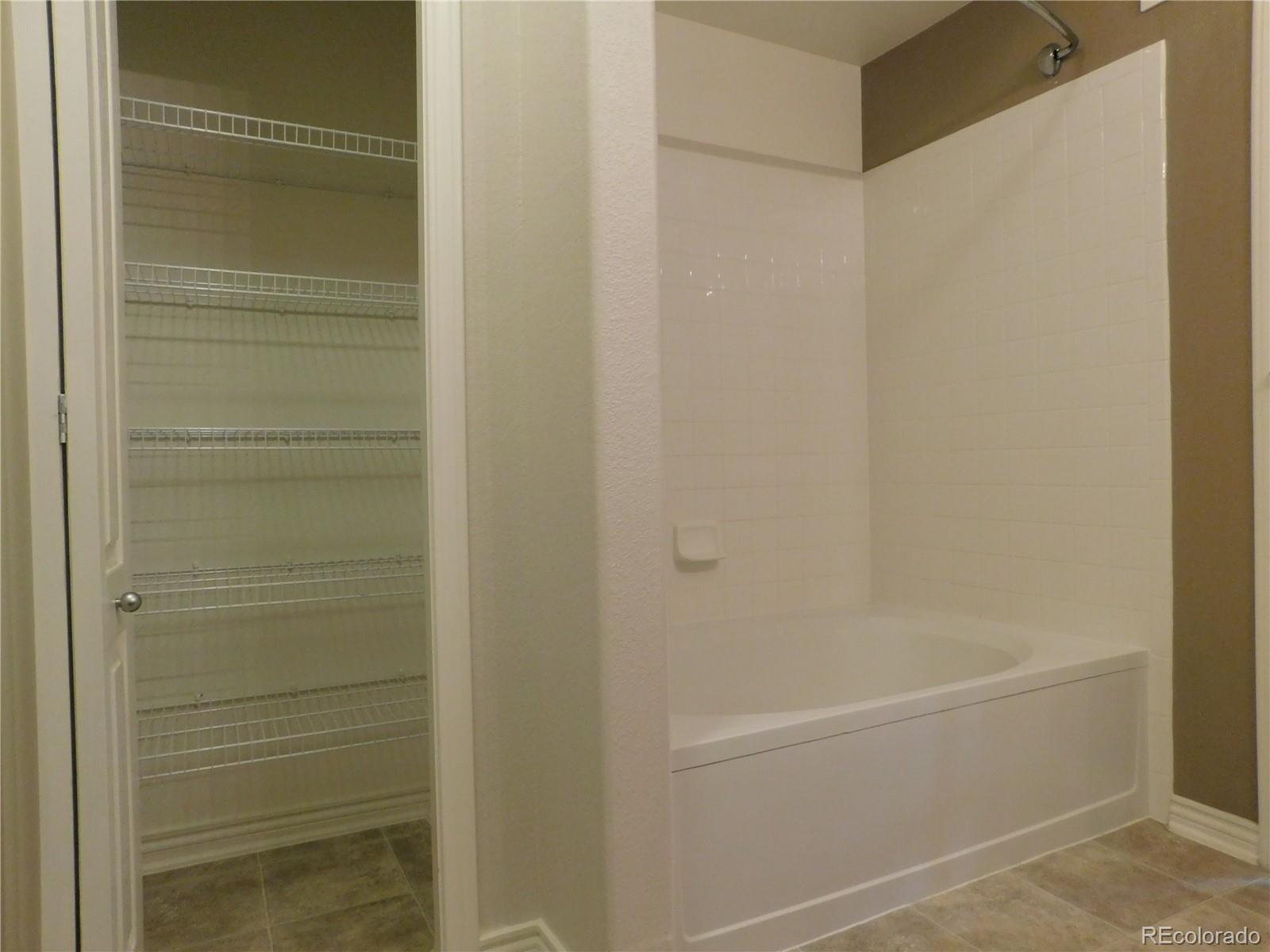 18669 Stroh Road, Unit 10204 Parker, CO 80134 - Photo 21 of 28 a bathroom with a bathtub