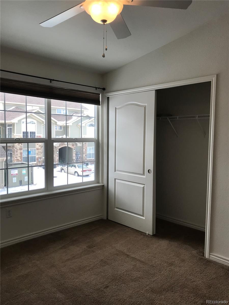 18669 Stroh Road, Unit 10204 Parker, CO 80134 - Photo 23 of 28 wooden floor in an empty room with a window