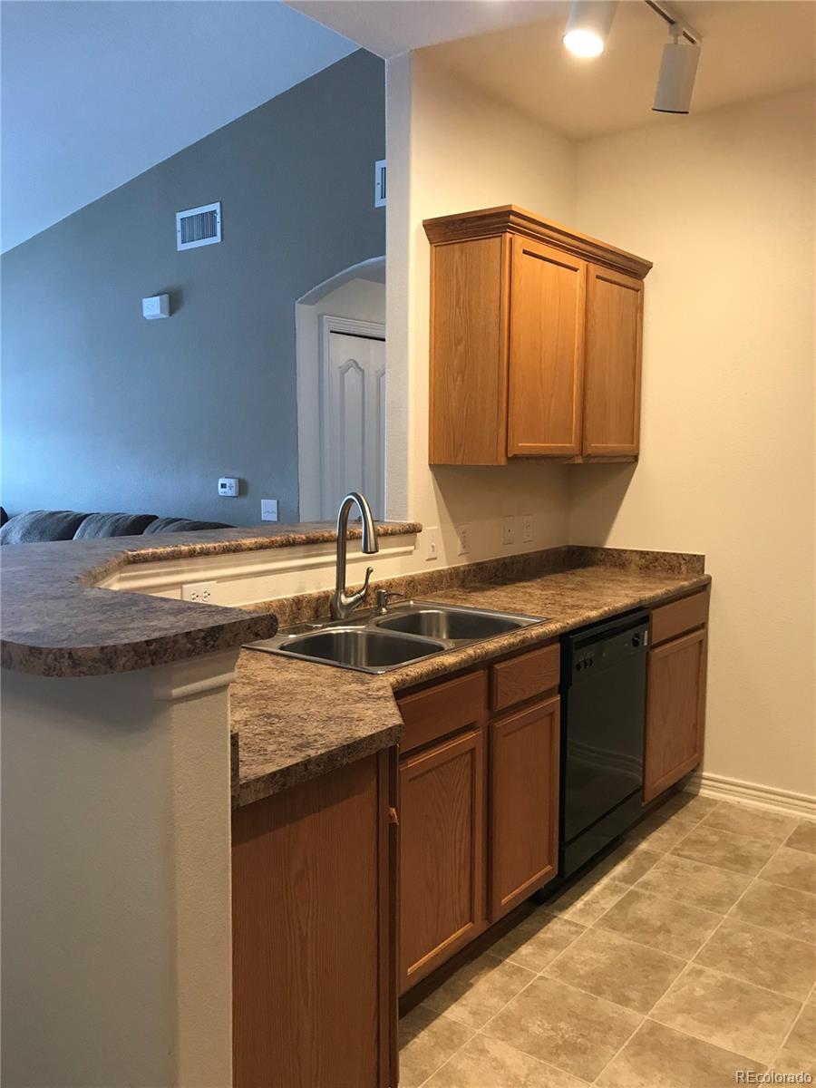 18669 Stroh Road, Unit 10204 Parker, CO 80134 - Photo 4 of 28 a kitchen with a sink and a cabinets