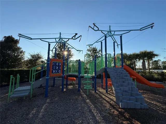 a view of a patio with a table chairs and a fire pit