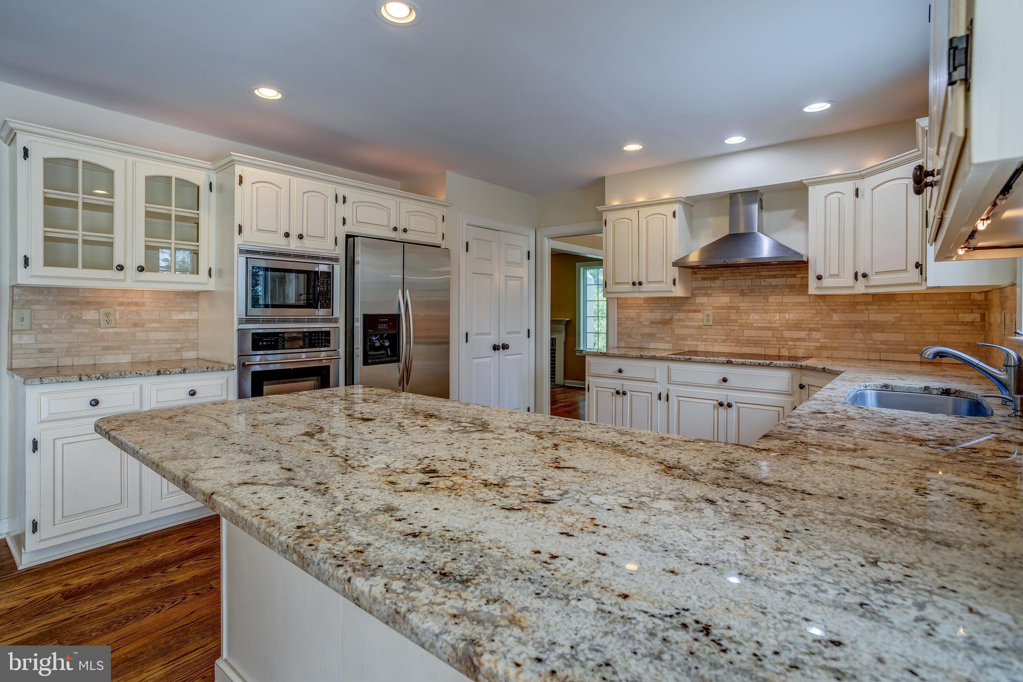 41 Old Covered Bridge Road Newtown Square, PA 19073 - Photo 17 of 58 a kitchen with stainless steel appliances granite countertop a refrigerator and a stove top oven