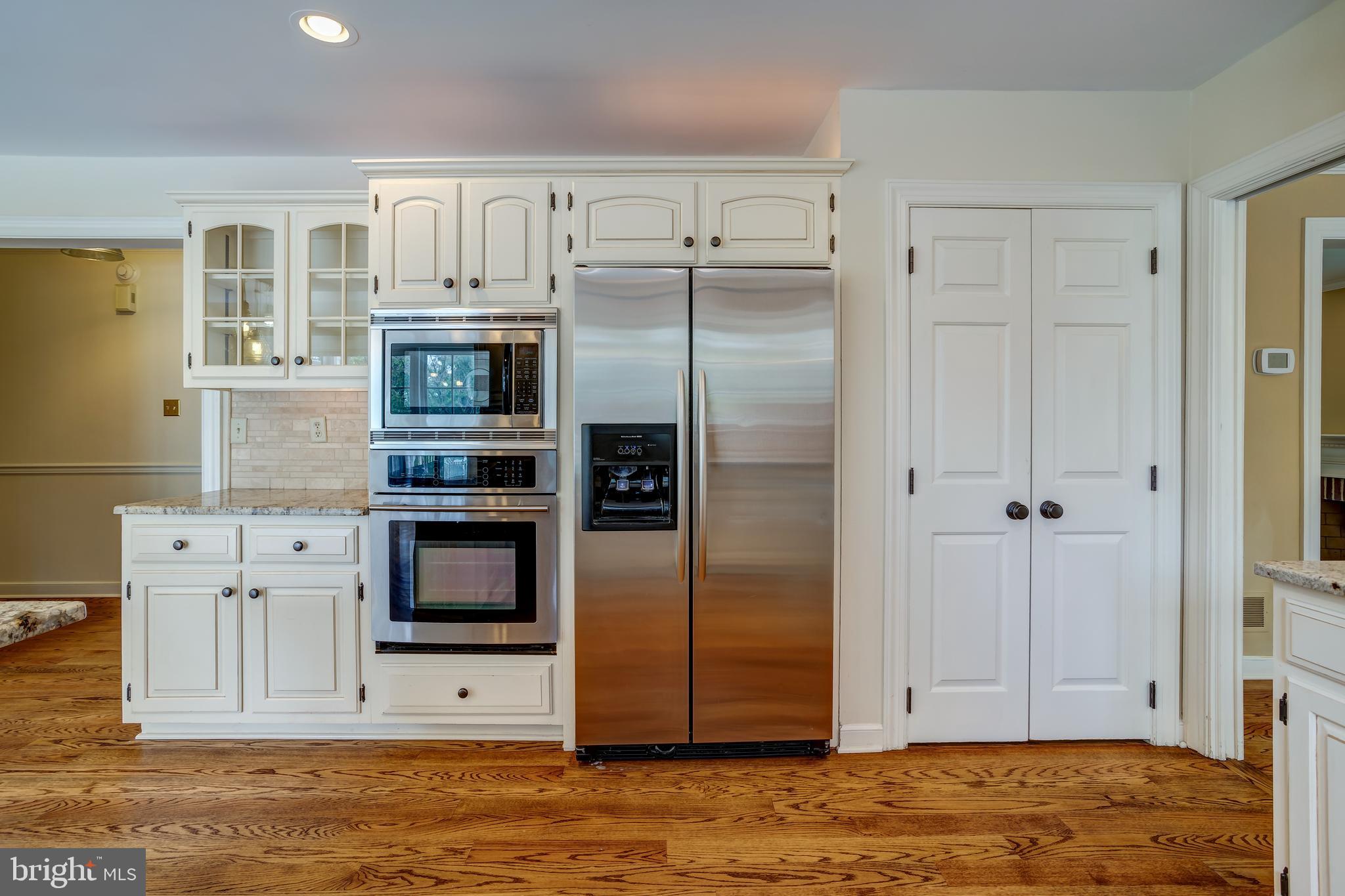 41 Old Covered Bridge Road Newtown Square, PA 19073 - Photo 18 of 58 a kitchen with stainless steel appliances white cabinets and wooden floor