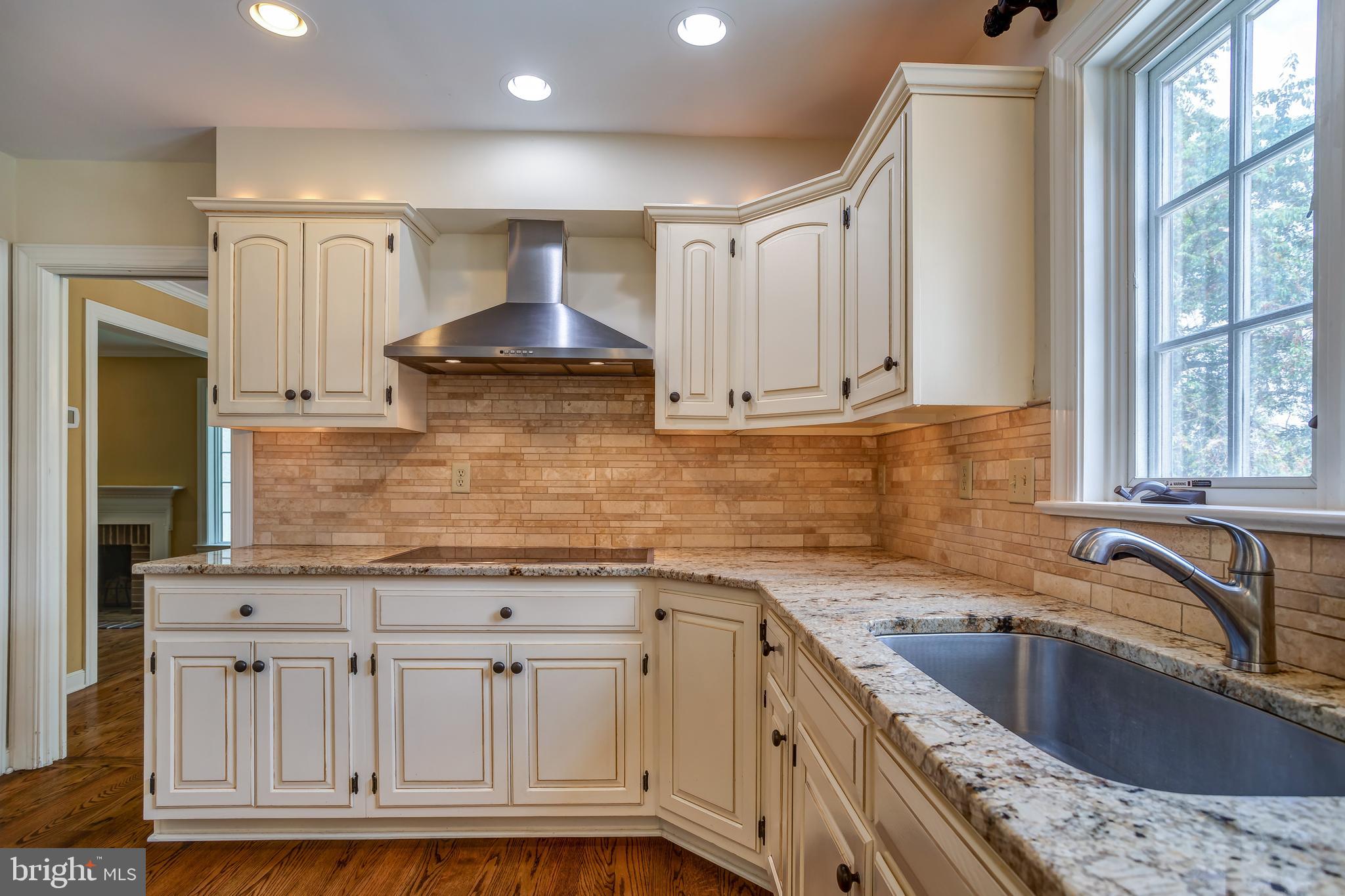 41 Old Covered Bridge Road Newtown Square, PA 19073 - Photo 19 of 58 a kitchen with granite countertop a sink stainless steel appliances and cabinets