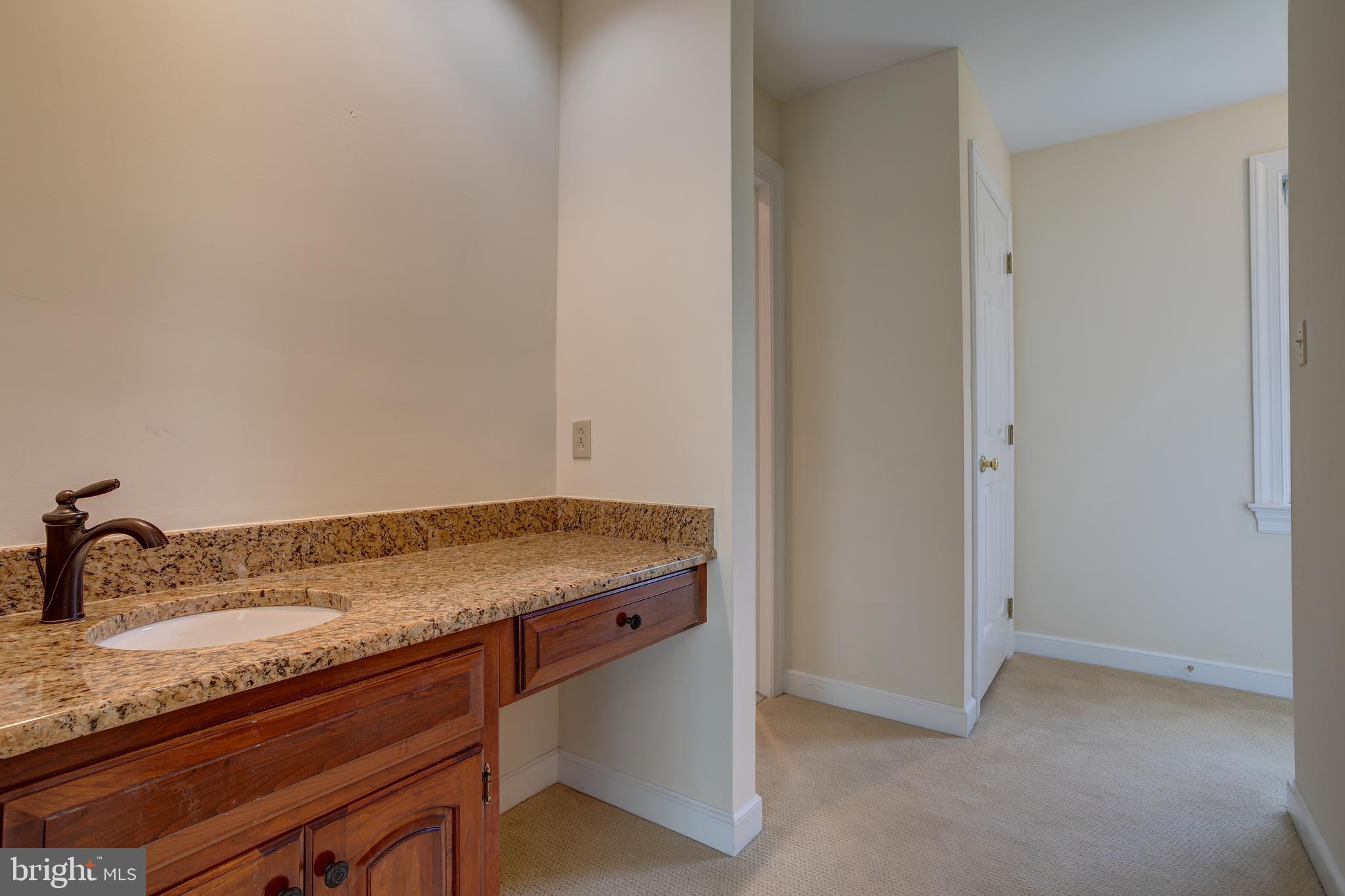 41 Old Covered Bridge Road Newtown Square, PA 19073 - Photo 34 of 58 a bathroom with a granite countertop sink and white cabinets