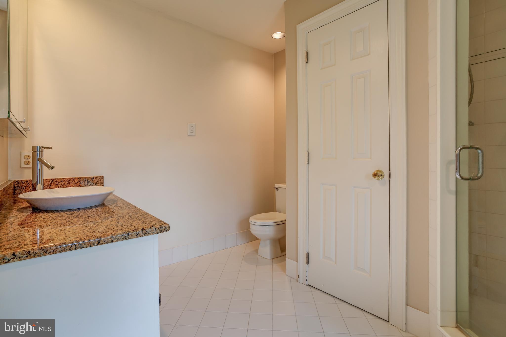 41 Old Covered Bridge Road Newtown Square, PA 19073 - Photo 39 of 58 a bathroom with a granite countertop sink and a toilet
