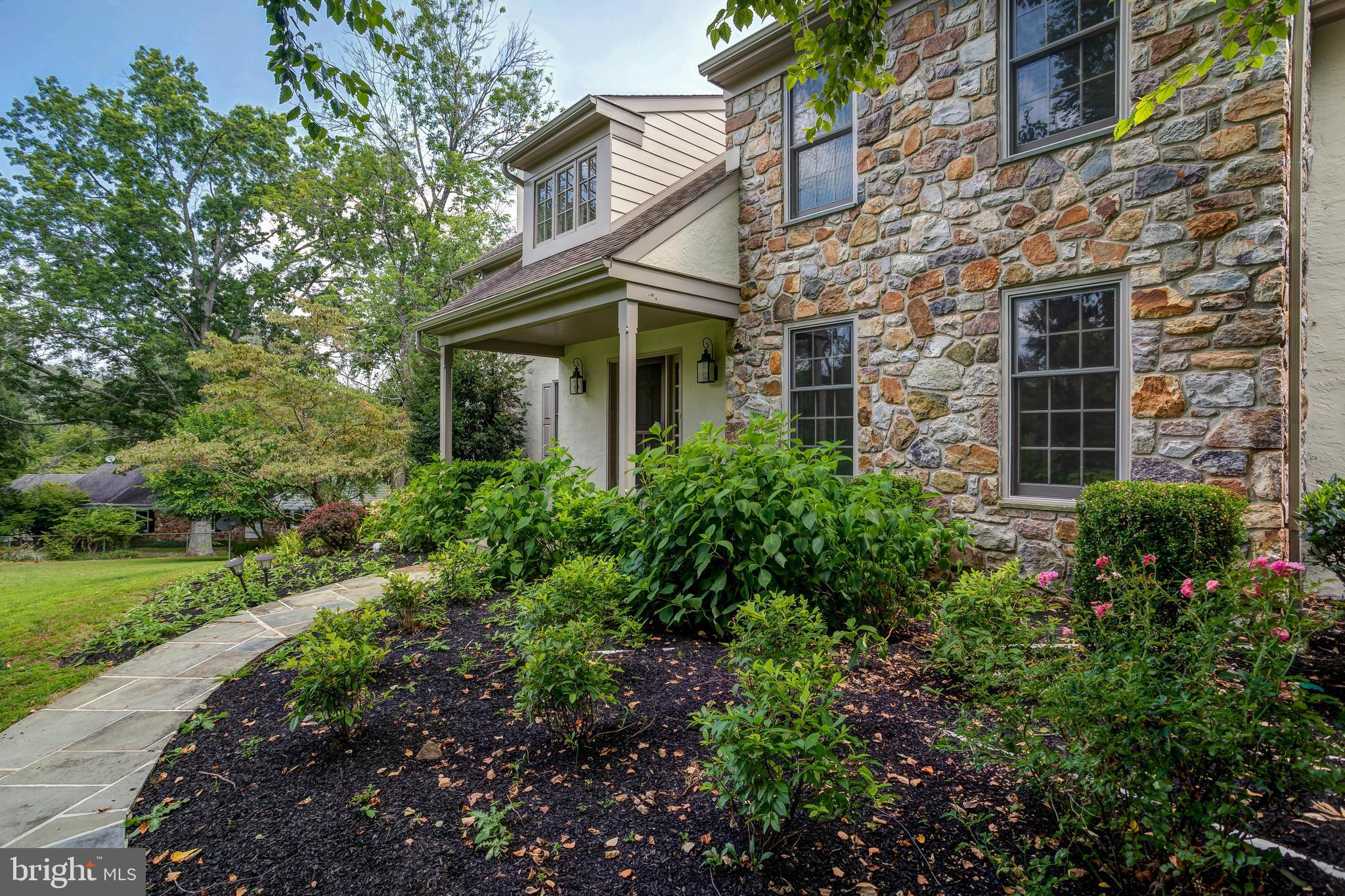 41 Old Covered Bridge Road Newtown Square, PA 19073 - Photo 5 of 58 a view of a brick house with a yard and plants