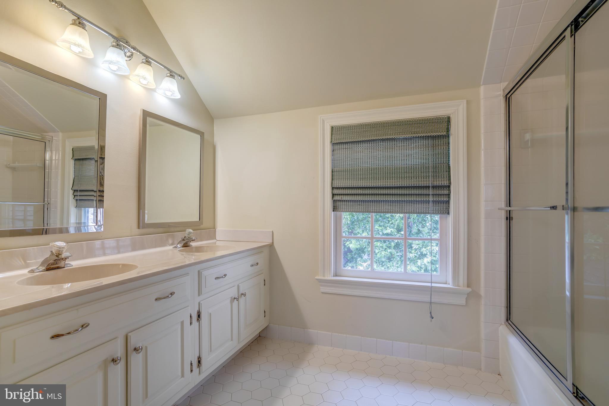 41 Old Covered Bridge Road Newtown Square, PA 19073 - Photo 44 of 58 a bathroom with a double vanity sink and a window