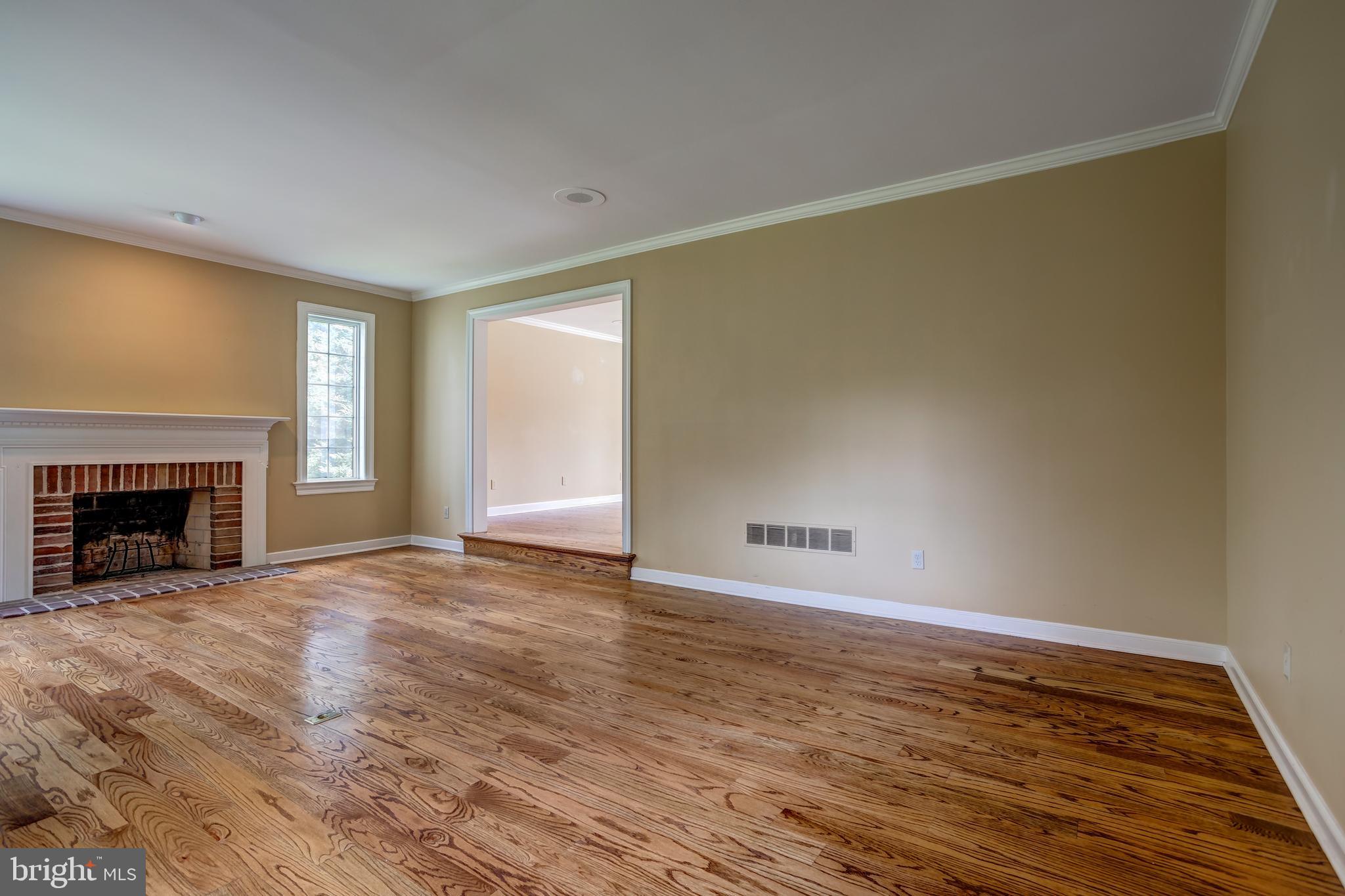 41 Old Covered Bridge Road Newtown Square, PA 19073 - Photo 10 of 58 a view of an empty room with wooden floor fireplace and a window