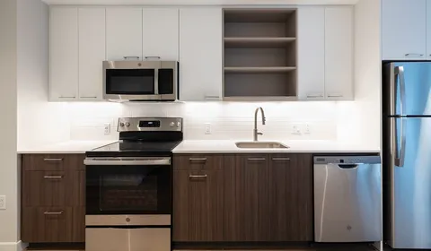 a kitchen with stainless steel appliances wooden cabinets and a sink