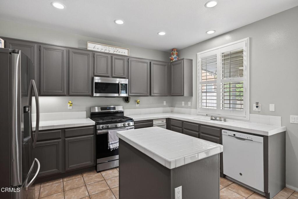816 Noontide Way Oxnard, CA 93035 - Photo 15 of 41 a kitchen that has a sink stainless steel appliances a window and a counter top space