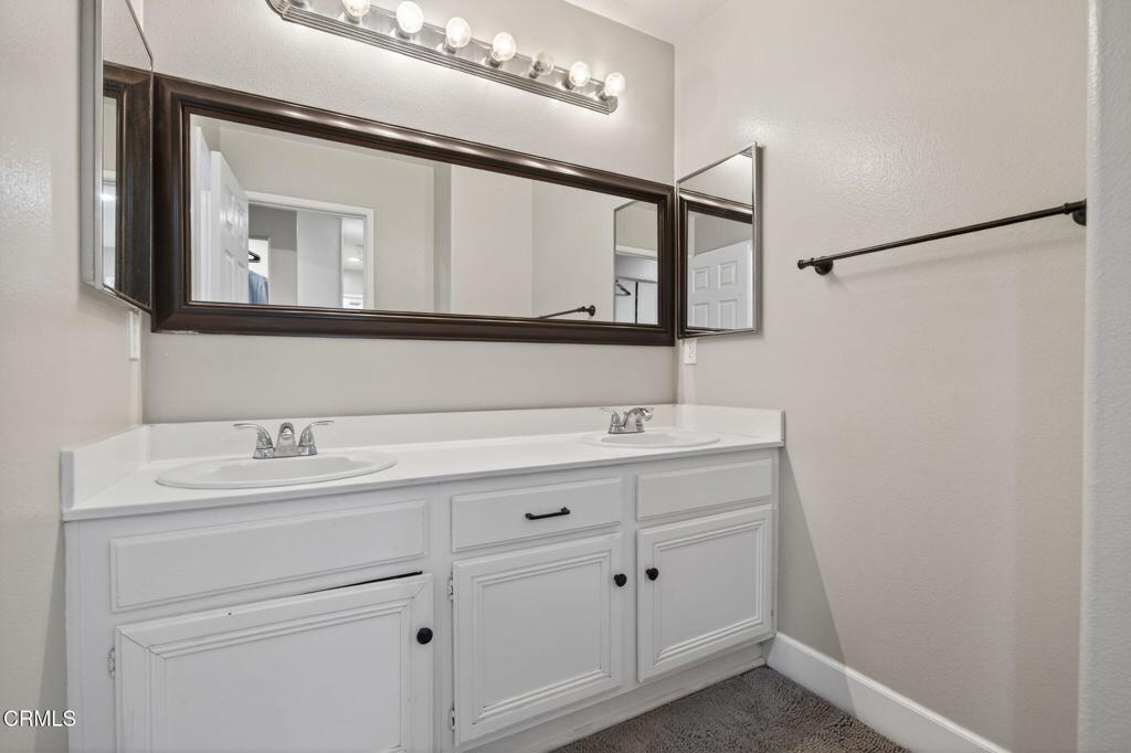 816 Noontide Way Oxnard, CA 93035 - Photo 24 of 41 a bathroom with a sink and a mirror