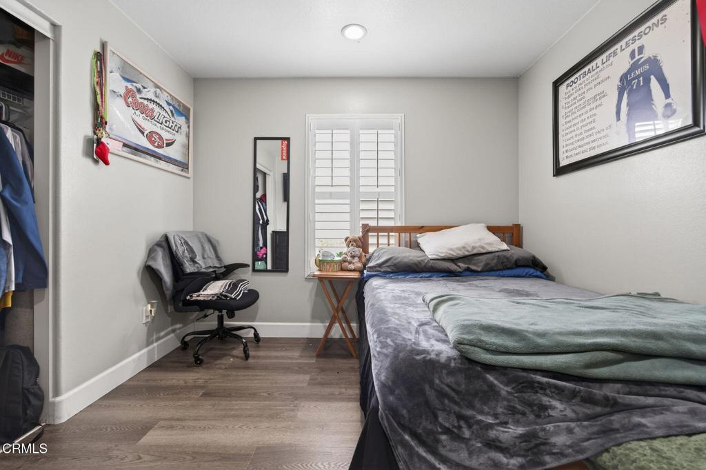 816 Noontide Way Oxnard, CA 93035 - Photo 25 of 41 a bedroom with a bed and wooden floor