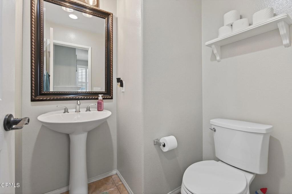816 Noontide Way Oxnard, CA 93035 - Photo 27 of 41 a bathroom with a toilet sink and mirror